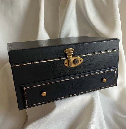 Vintage black vinyl covered jewelry box with gold accents, red velvet and satin interior