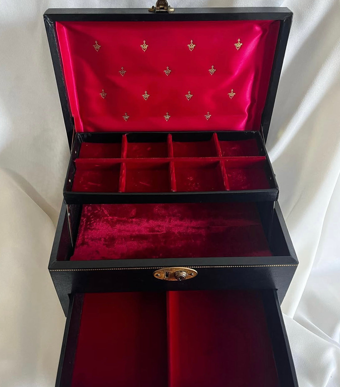 Vintage black vinyl covered jewelry box with gold accents, red velvet and satin interior